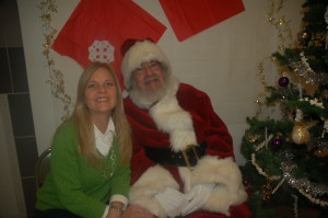 Excited Volunteer Michelle poses with a jolly Santa