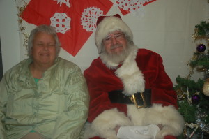 Patty happily sitting with joyful Santa