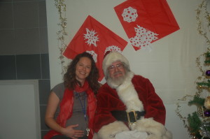 A joyful Executive Director Barbara Runco celebrates with Santa