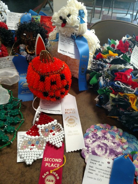 Handmade Halloween-themed crafts including a red pumpkin and decorated ornaments.