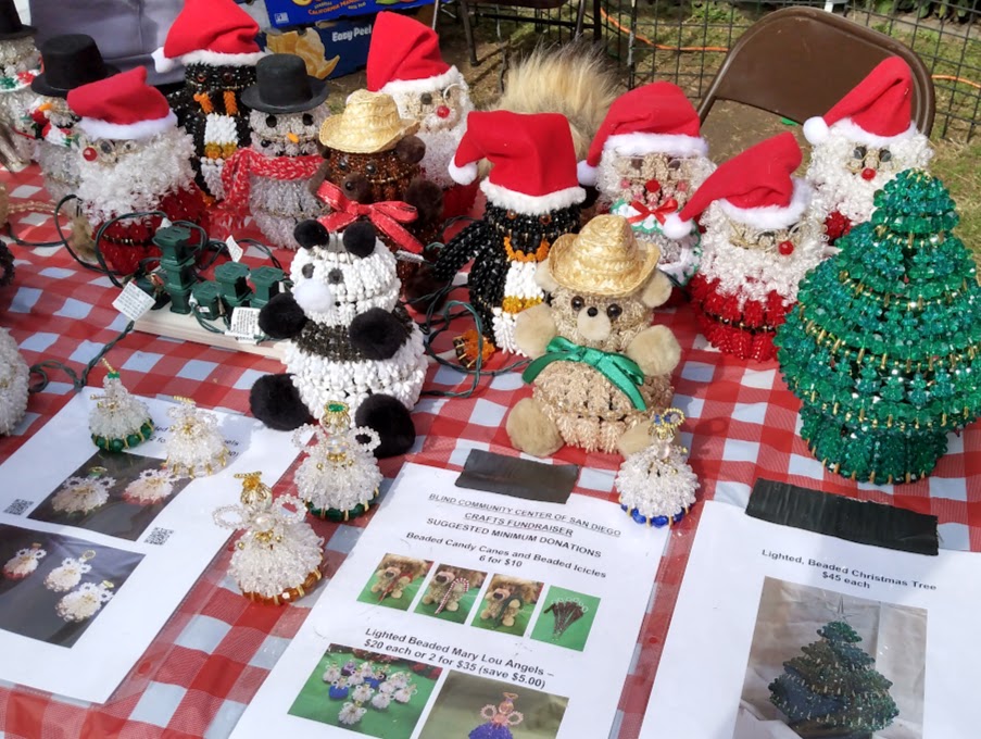 Handmade Christmas-themed crochet dolls displayed on a table.